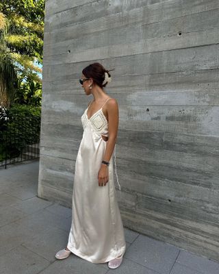 Débora Rosa in a white slip maxi dress on vacation.