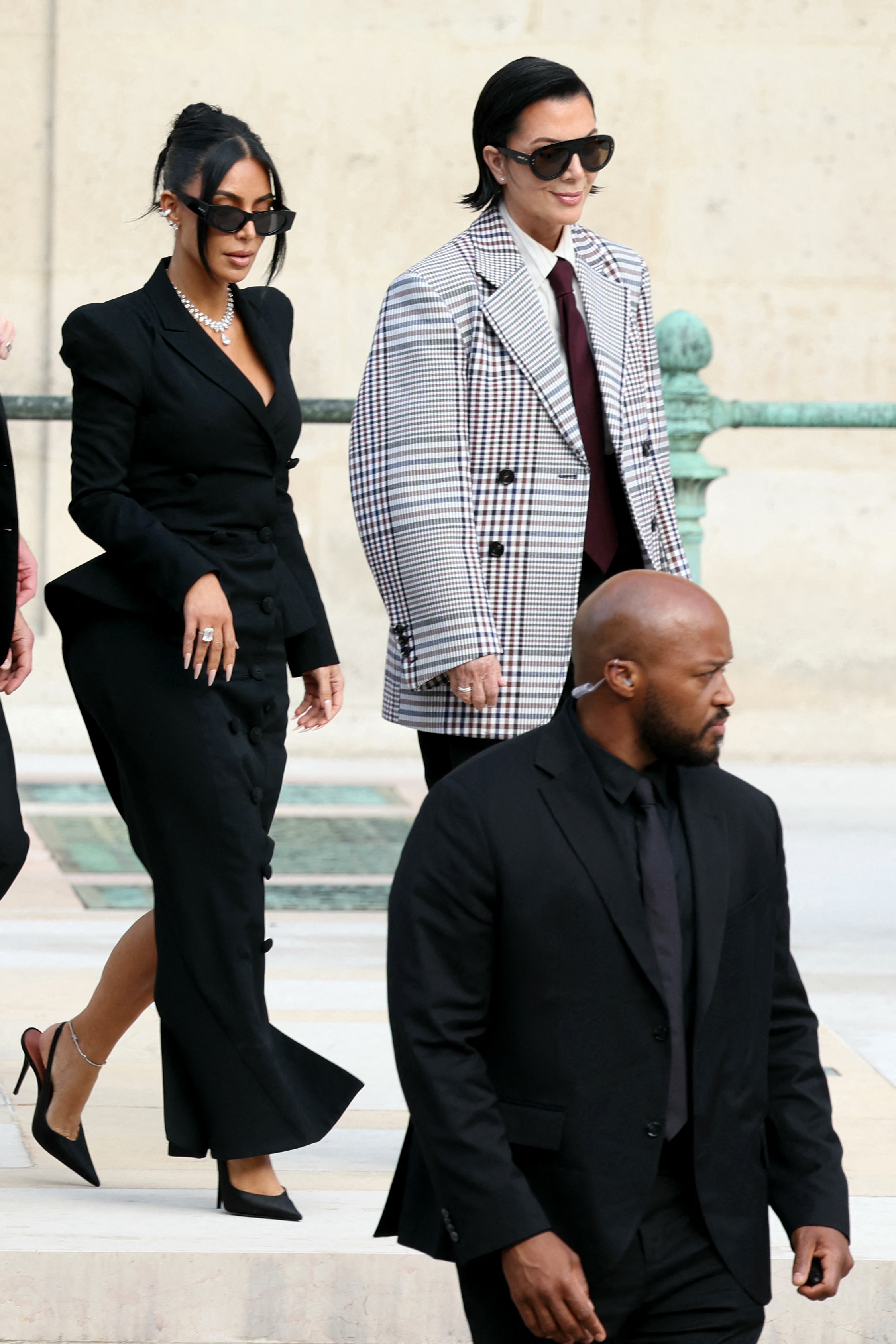 Kim Kardashian wearing a diamond anklet while leaving a courthouse with Kris Jenner