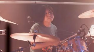 Yoyoka Soma sits behind a drum kit