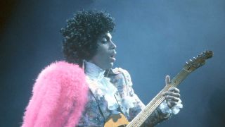 Prince onstage with his guitar
