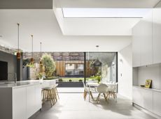 An open plan kitchen with pendants and statement lighting