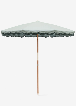 green beach umbrella with a scallop-edge border