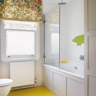 bathroom with yellow floor and shower