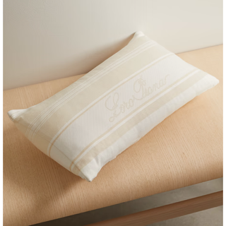 cream pillow with embroidered logo