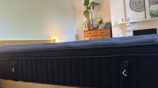 Close detail images of the DreamCloud Luxe Memory Foam mattress, showing design features like the quilted top of the bed and the handles sewn onto the sides