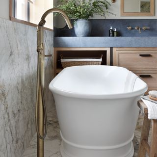 close up of a stylish bath tub with floor-standing mixer tap