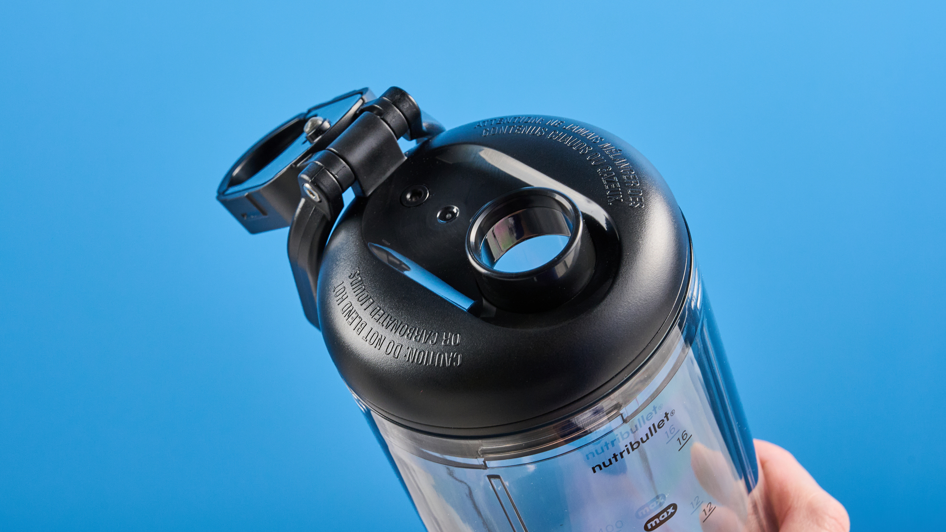 Nutribullet Flex blender photographed on a blue background