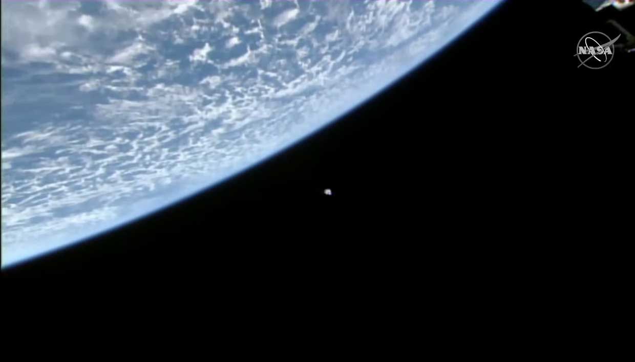 SpaceX's Dragon CRS-23 cargo ship is seen with a bright blue Earth as a backdrop by a camera on the International Space Station during its docking approach on Aug. 30, 2021.