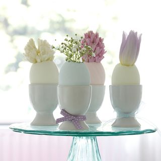 cups hold pastel painted eggs