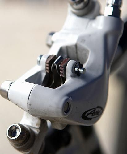 New top-loaded pads are secured with a simple pin-and-clip arrangement. The larger window affords better cooling, too.