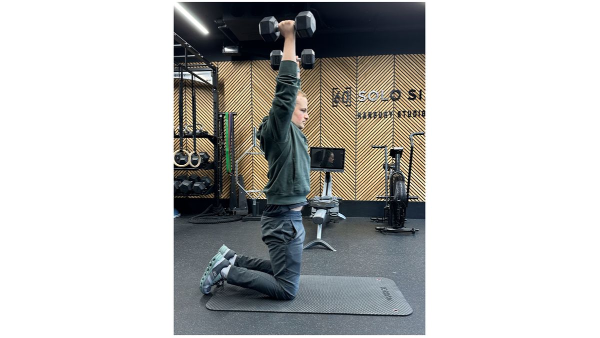 Ollie Thompson completing a tall-kneeling biceps curl and press