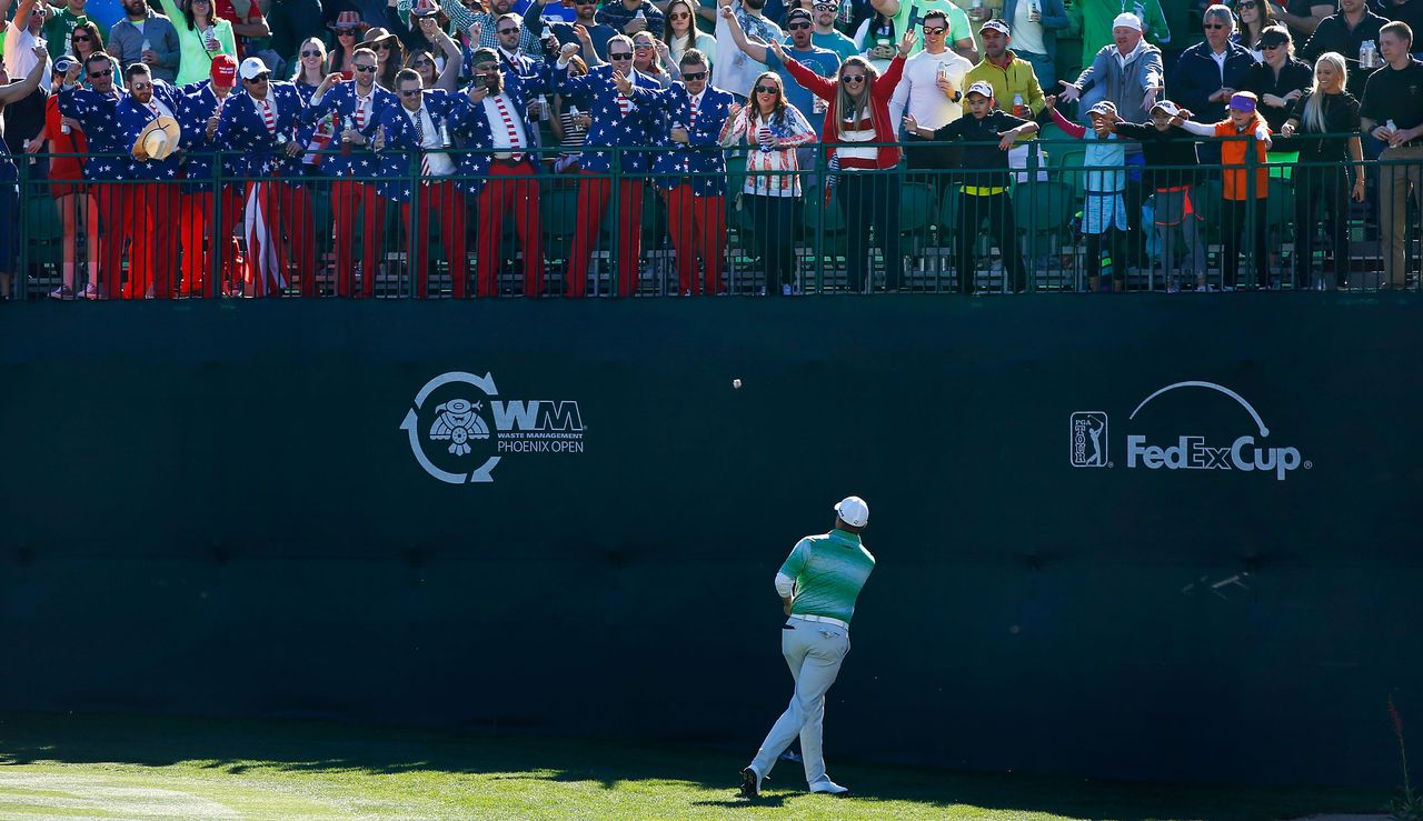 Palmer throws a golf ball wrapped in money to the crowd