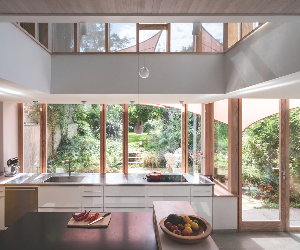 Kitchen with windows overlooking the garden behind the worktop cooking space