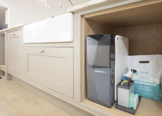 a water softener installed under a kitchen sink