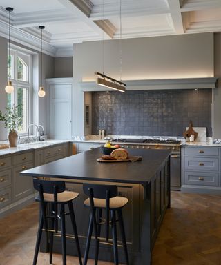 gray kitchen with dark island and wood floors