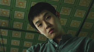 Choi Woo-shik as Kim Ki-woo looking down at Scholar's Rock in Parasite