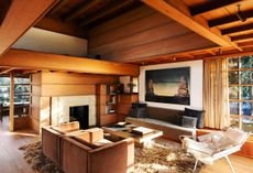 at how house, Leo Mock’s O river of flowers presides over the living area, which is furnished with a pair of custom-made armchairs and a Hans Wegner ‘Flag Halyard’ chair