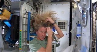 Astronaut Nyberg Applies Water to Hair