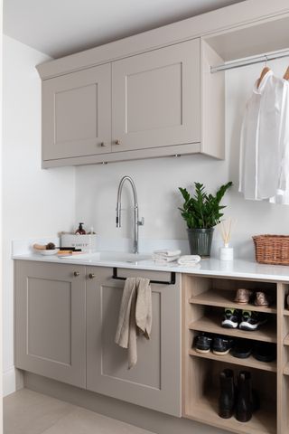 practical brown utility room with shoe storage