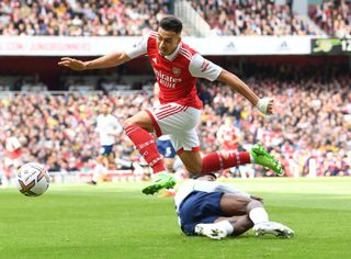 Arsenal star Gabriel Martinelli jumps the challenge from Emerson Royal of Tottenham during the Premier League match between Arsenal FC and Tottenham Hotspur at Emirates Stadium on October 01, 2022 in London, England.