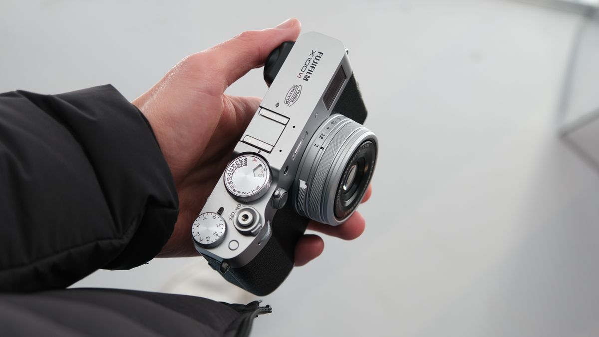 Fujifilm X100VI camera held in a hand