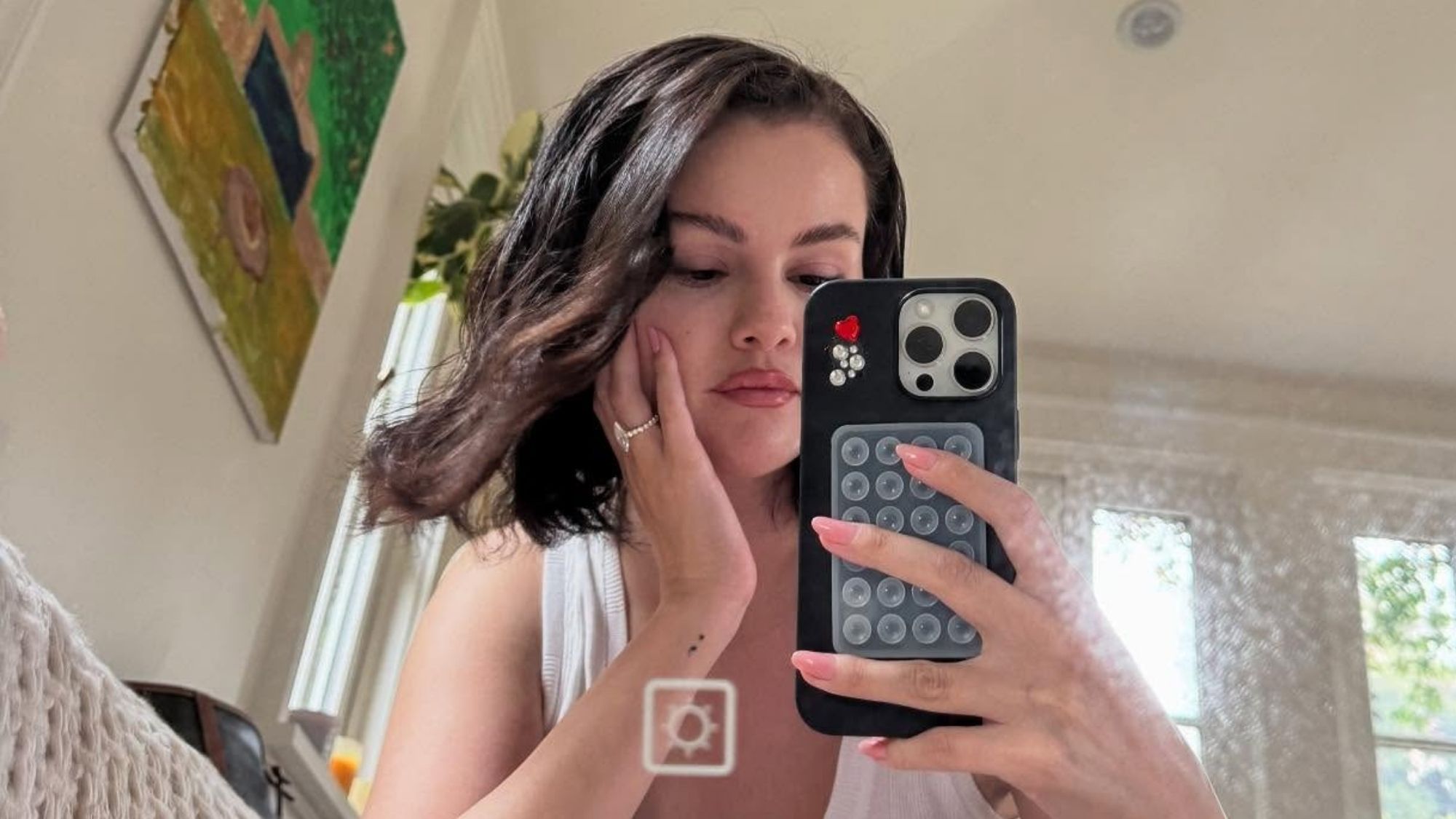 Selena Gomez taking a mirror selfie.
