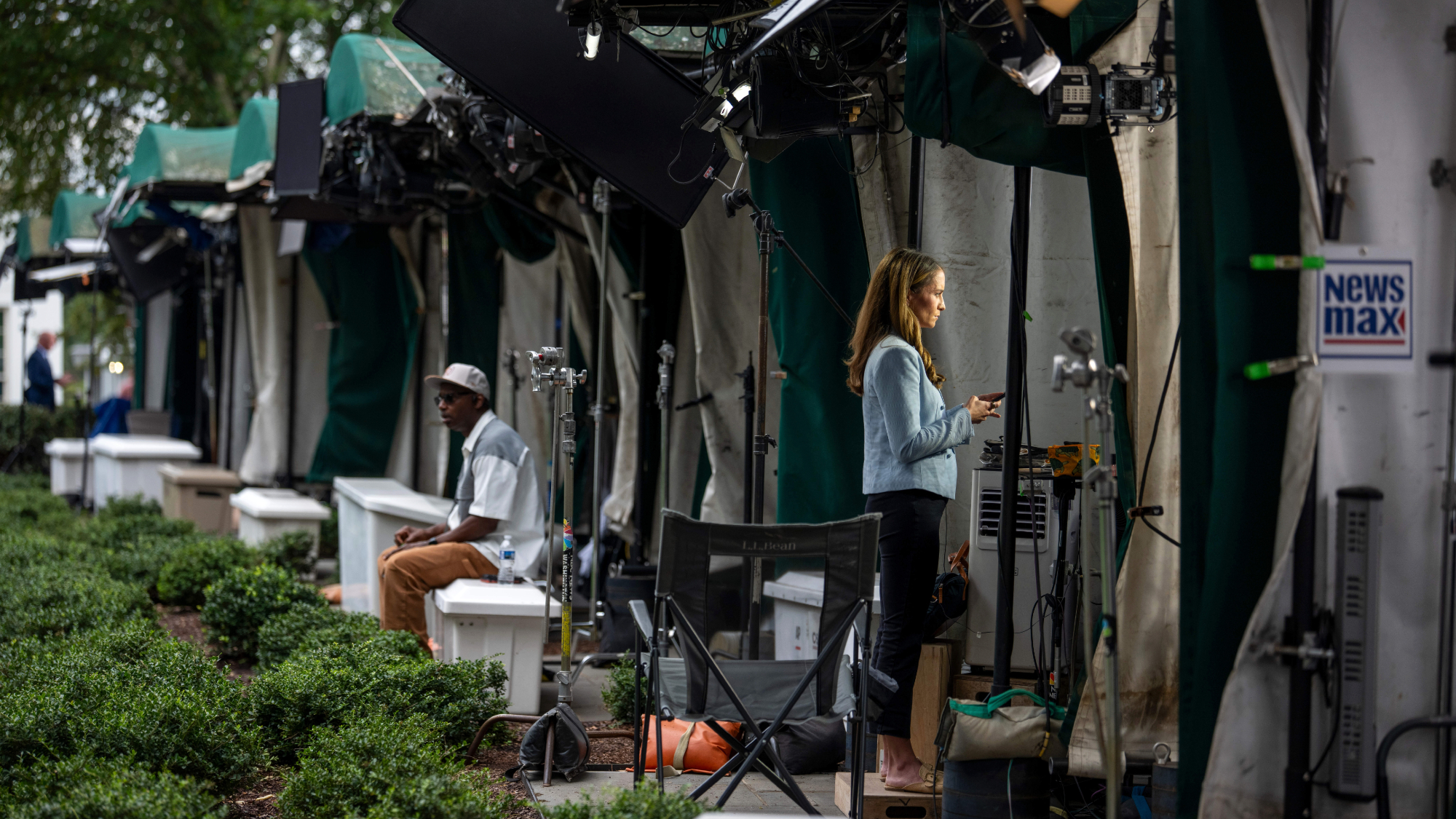 A member of the media outside the White House after three media outlets announced they will sue to maintain their ability to enter the White House grounds and other networks stopped filming.