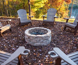 fire pit and chairs on bark chipping patio