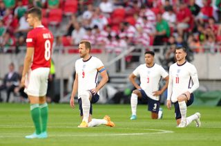 England players take the knee ahead of the game in Hungary