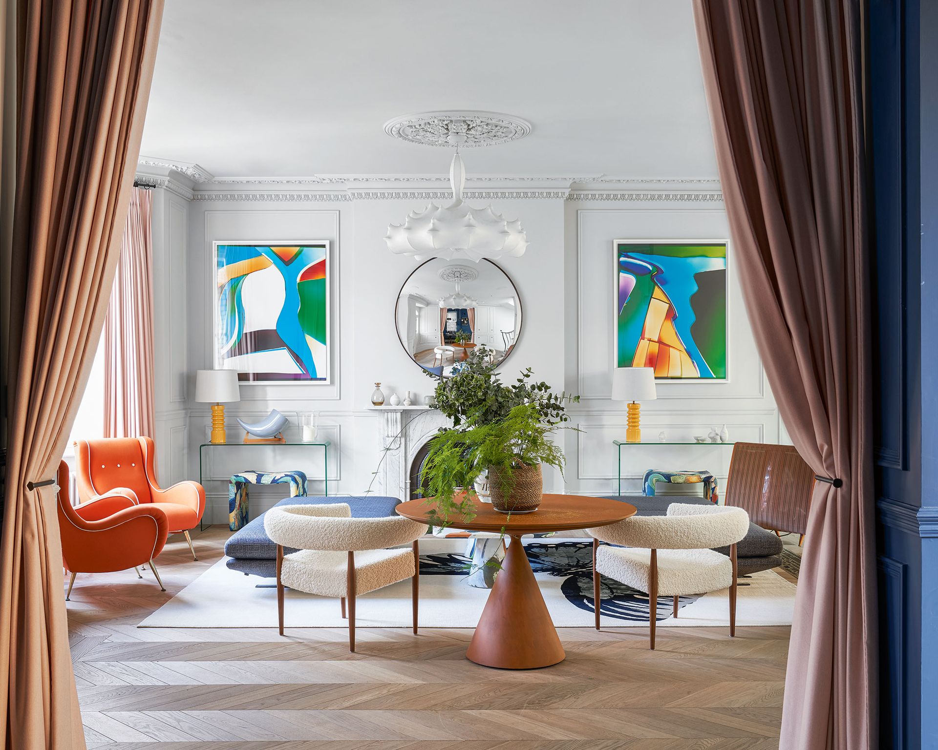 Mid-century modern style living room with modern art, white walls and curved chairs