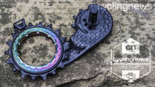 AbsoluteBlack Hollowcage Carbon Ceramic Oversized pulley arranged on a stone backdrop