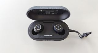 Lypertek PurePlay Z3 2.0 review: headphones in a charging case on a white desk