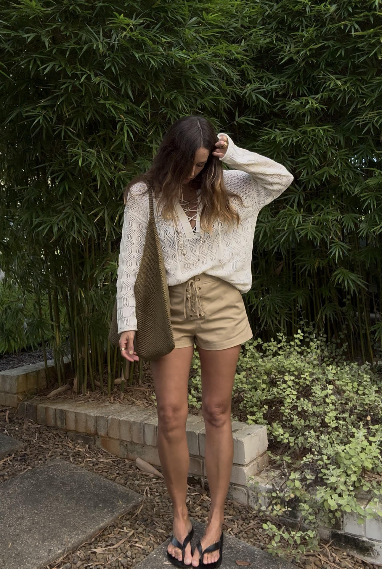 Angie wears a blouse and shorts from A.L.C.
