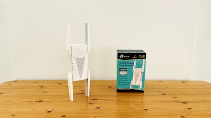 TP-Link AXE5400 range extender on wooden table
