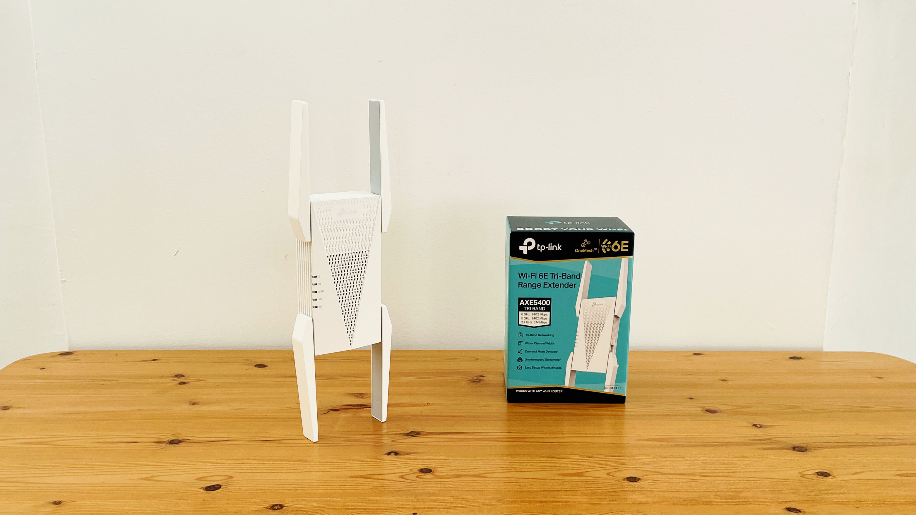 TP-Link AXE5400 range extender on wooden table