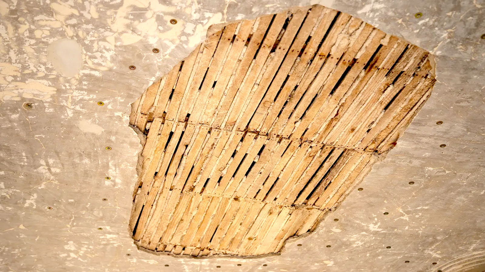 Lathe and plaster ceiling with patch of laths exposed