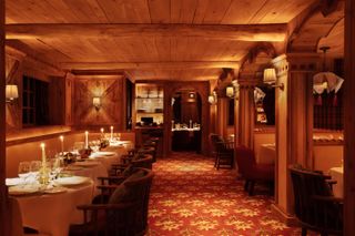 Wood-ceilinged dining room at Loulou Courchevel