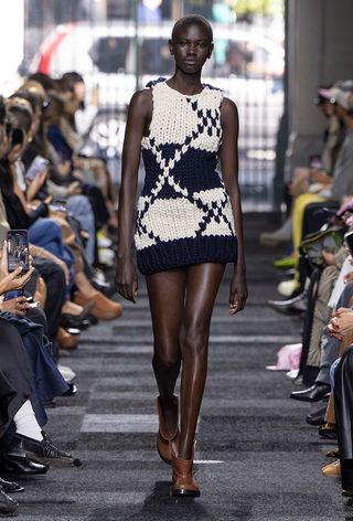 a model on the JW Anderson spring 2025 runway wearing the surreal knitwear trend