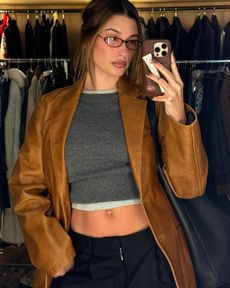 hailey bieber wearing leather blazer and cropped sweater