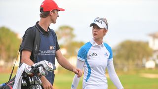 Sebastian caddies for Nelly Korda at the 2021 PNC Championship