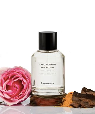 Rosamunda fragrance by Laboratorio Olfattivo in glass bottle next to pink rose