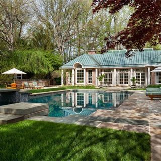 house pool with grass and trees