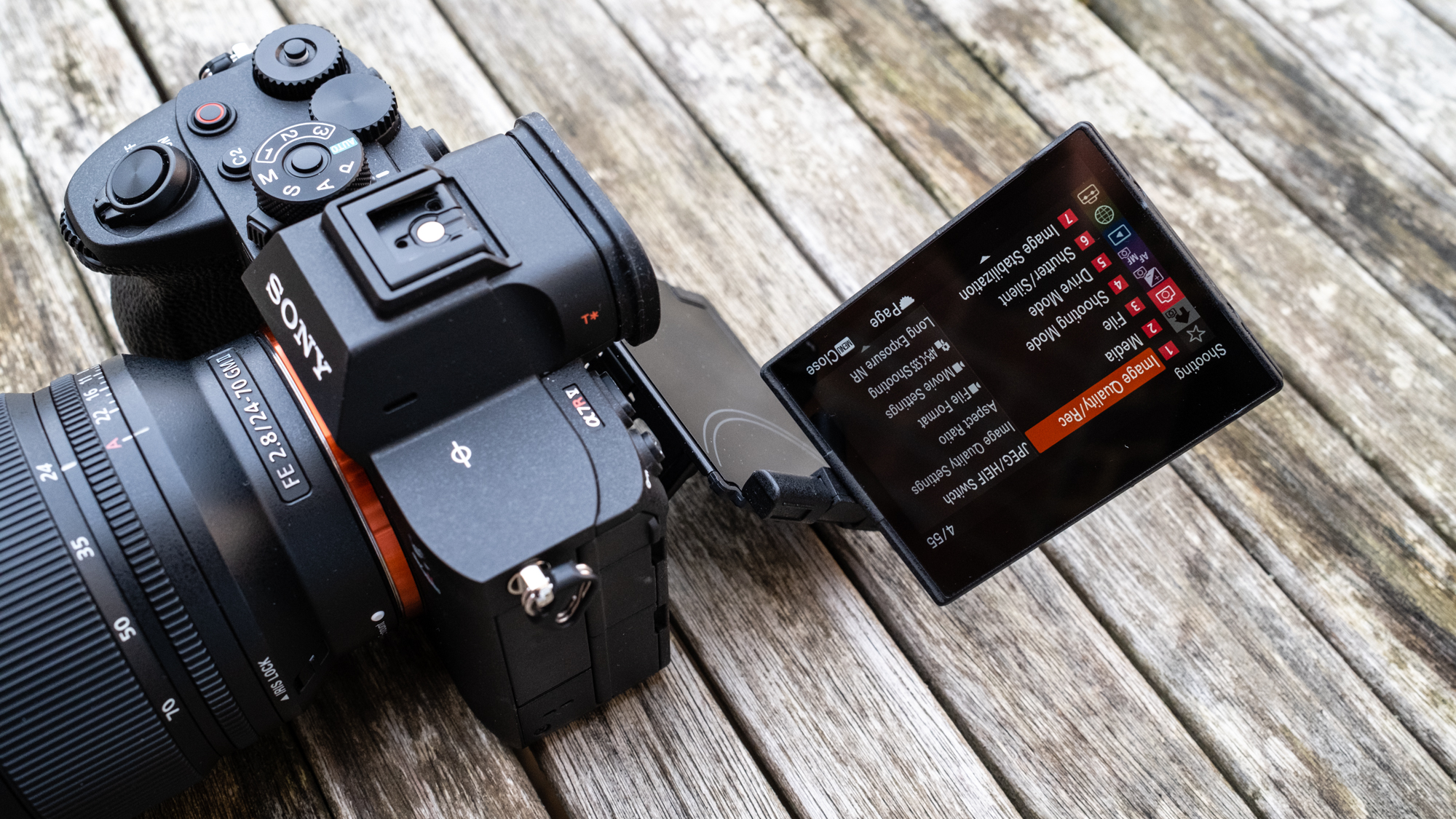 The Sony A7R V on a table with dual hinge screen flipped out