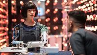 A man faces the realistic artist" robot "Ai-Da" using artificial intelligence at a stand during the International Telecommunication Union (ITU) AI for Good Global Summit in Geneva on May 30, 2024. 