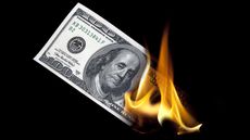 one-hundred dollar bill on fire
