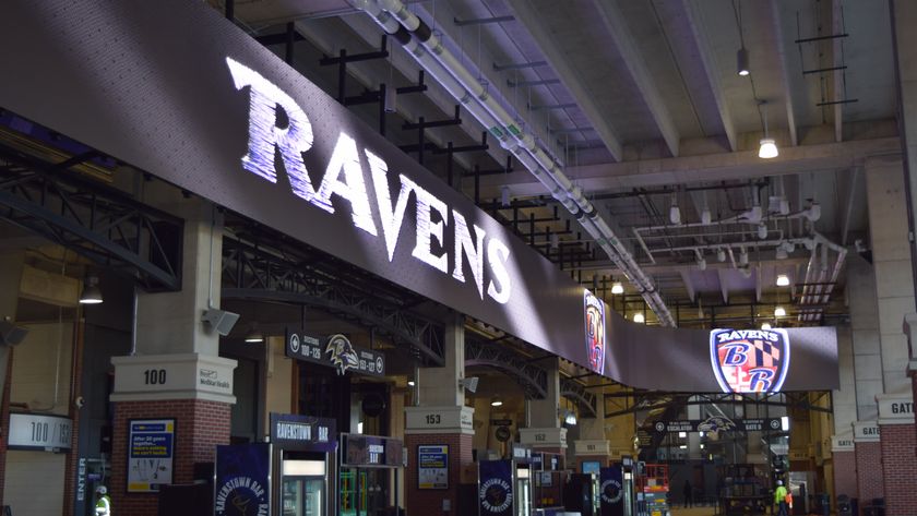 Inside of the Baltimore Ravens stadium with a big digital RAVENS alit. 