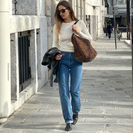 style influencer Anne-Laure Mais wearing a chic jeans and boots outfit for 2025 2026