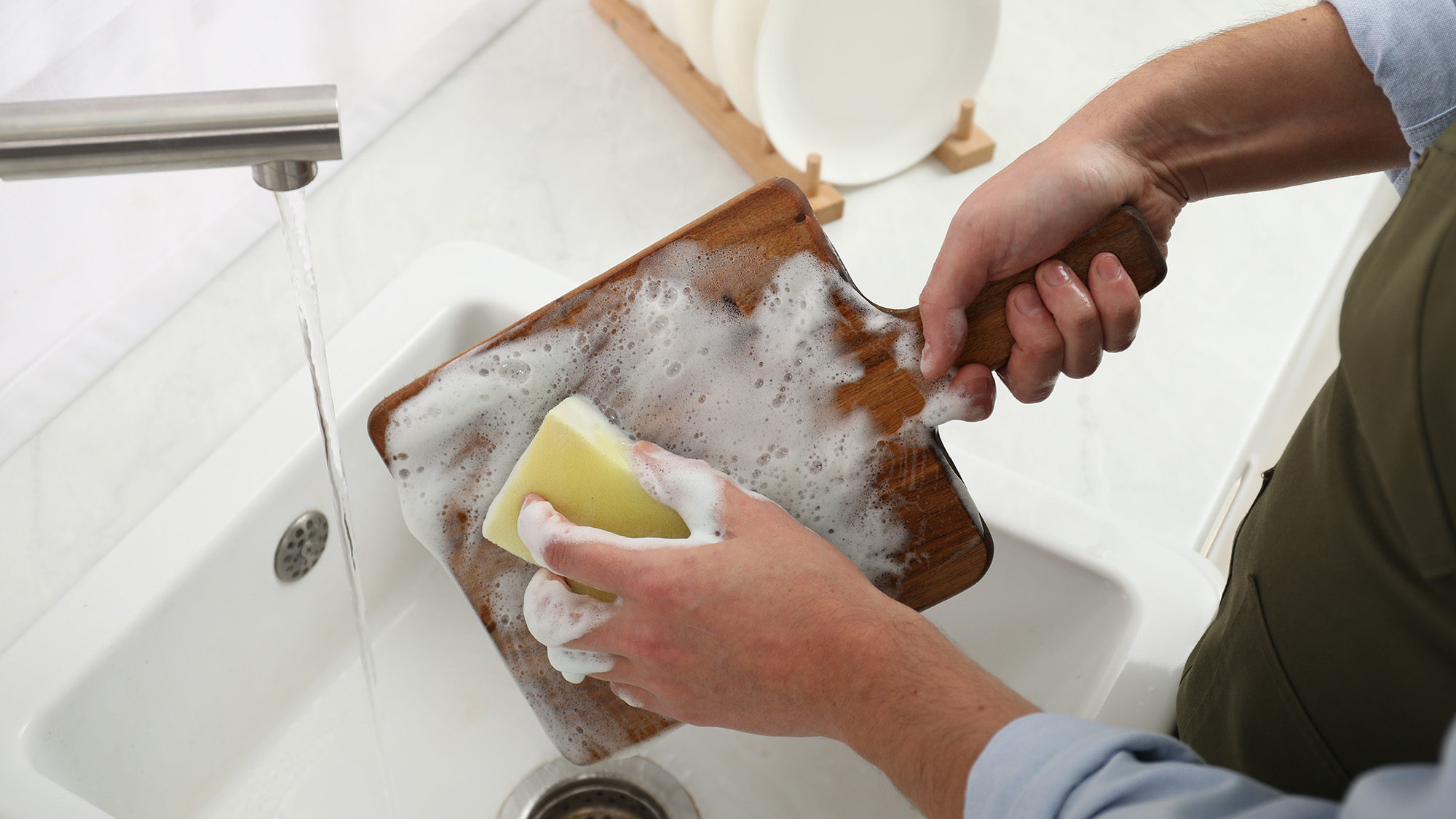 Man cleaning wooden chopping board