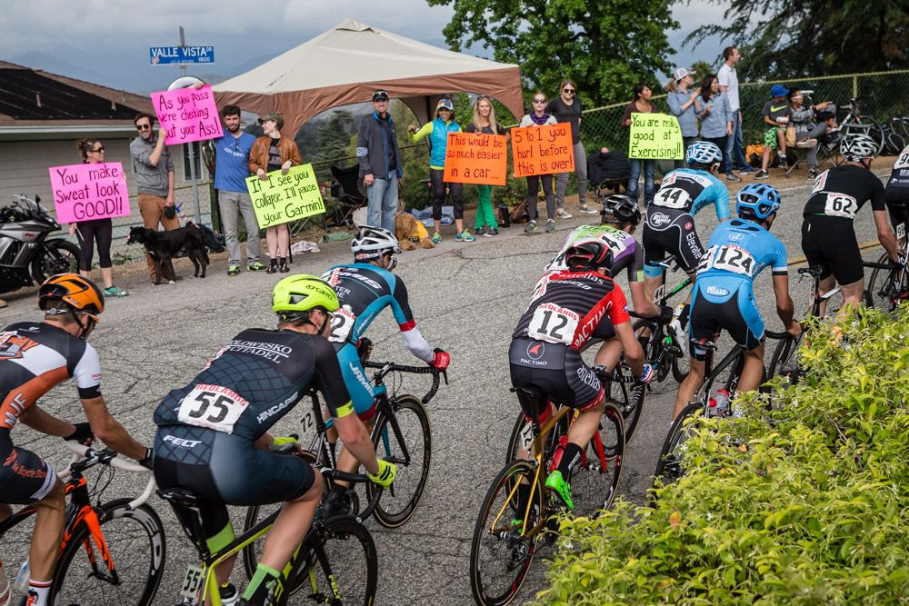 Some fans line the road with humorous signs to distract the riders from the pain of climbing Vella Vista