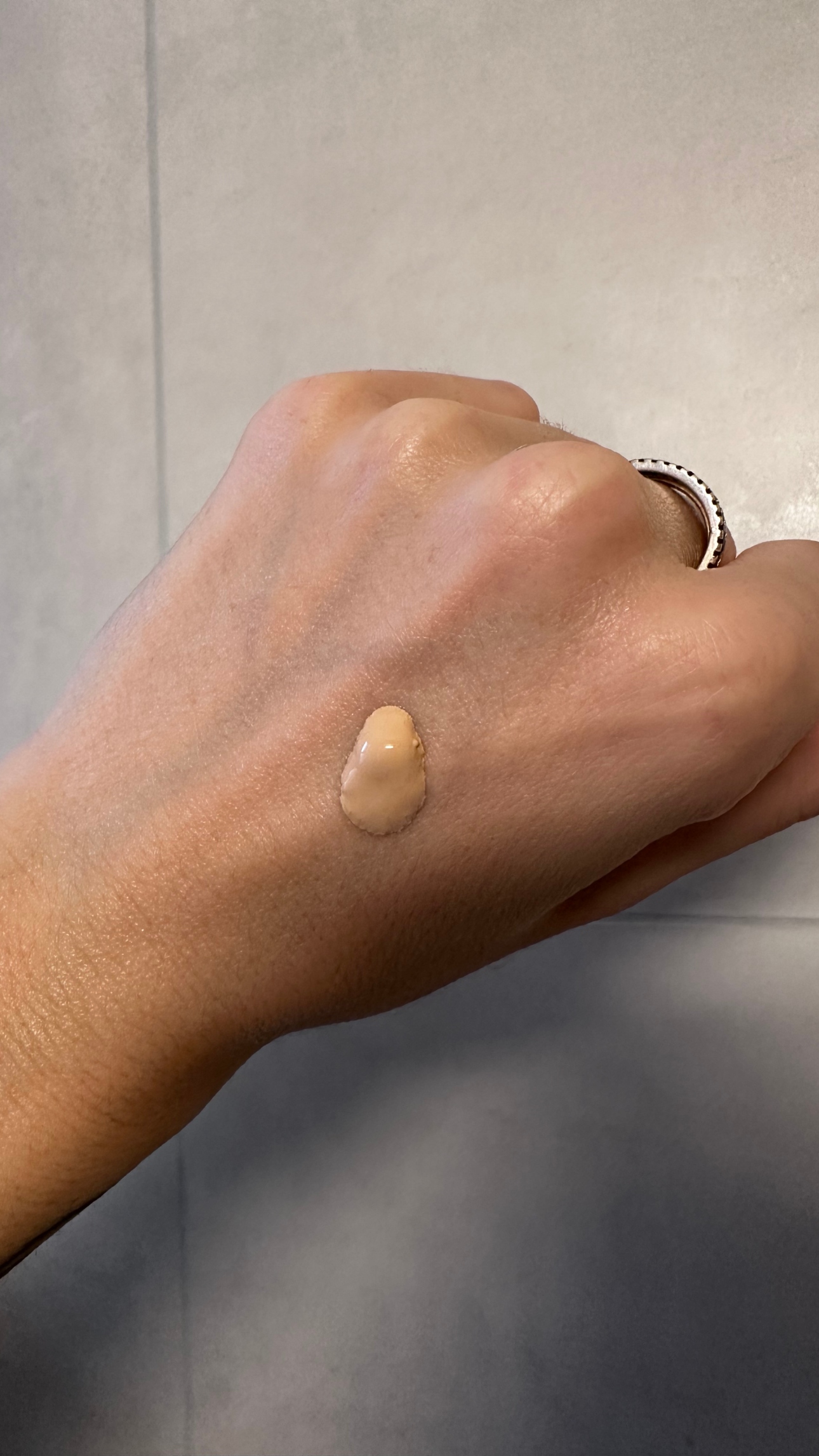 Hannah Baxter's hand with foundation on the back